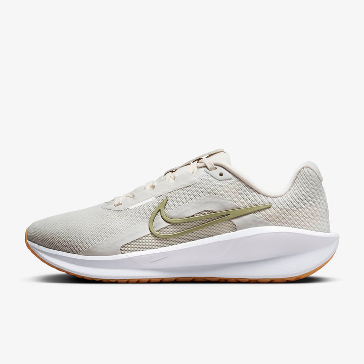 A side-angle view of Nike women’s lace-up running shoes showcasing the sleek profile, cushioned sole, and iconic Nike swoosh, set against a clean background for a modern look