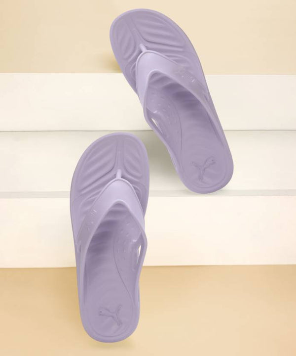 Side view of PUMA Women's Slippers, showcasing the soft plush interior, non-slip outsole, and iconic PUMA logo, designed for comfort and stability during indoor wear.